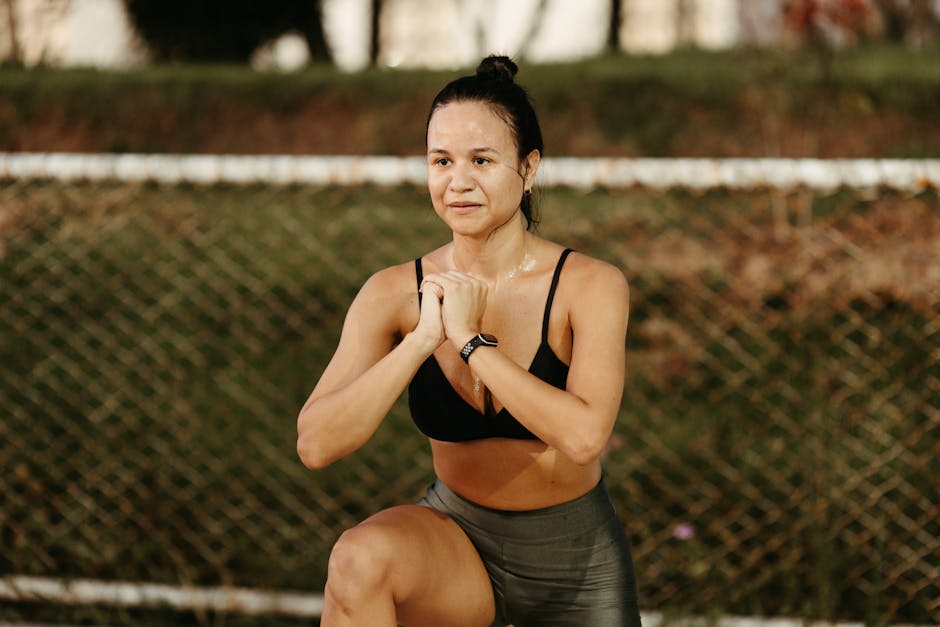 Woman doing squats in a park, embracing fitness and healthy lifestyle.